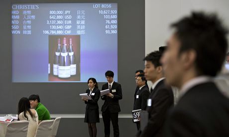 Christie's employees take notes during the auction