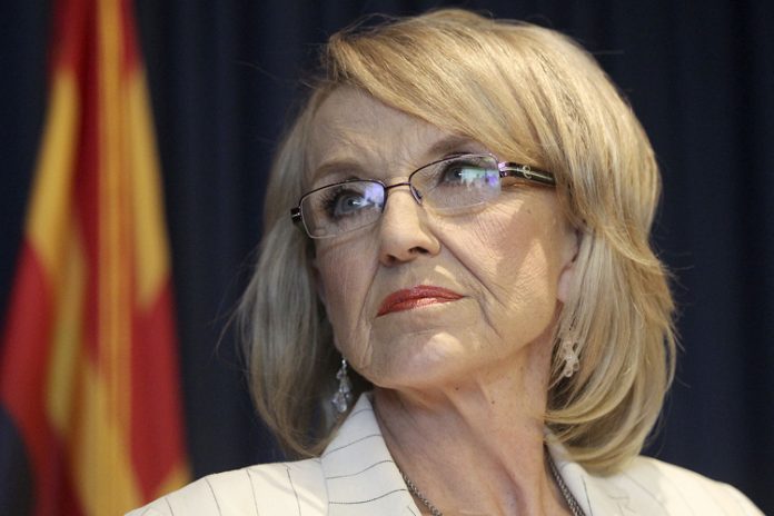 Arizona Governor Jan Brewer listens to a question from a media member about the Supreme Court's decision on SB1070 in Phoenix.