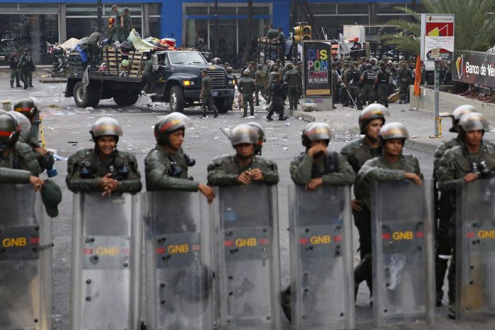 Venezuela's national guard dismantle an anti-government protester's camp site in front of U.N. offices at Chacao district in Caracas