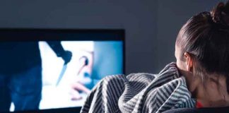 Una mujer sentada viendo una película de terror en su tv / Imagen referencial / Pixabay