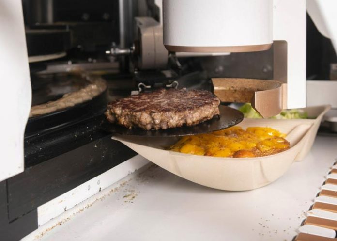 perross Robots trabajan juntos para cocinar una hamburguesa