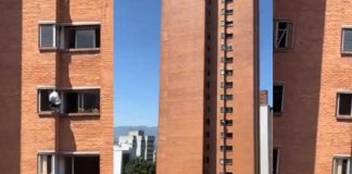 Mujer se pone en riesgo al limpiar la ventana de su casa en un décimo piso