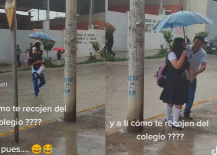 4 Padre carga a su hija para que su uniforme no se ensucie