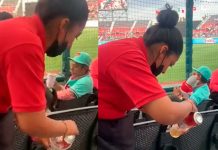 ¡Asquerosa! ‘Escurre’ latas con sobras de cervezas para volverlas a vender Vendedora de cervezas en un estadio de México